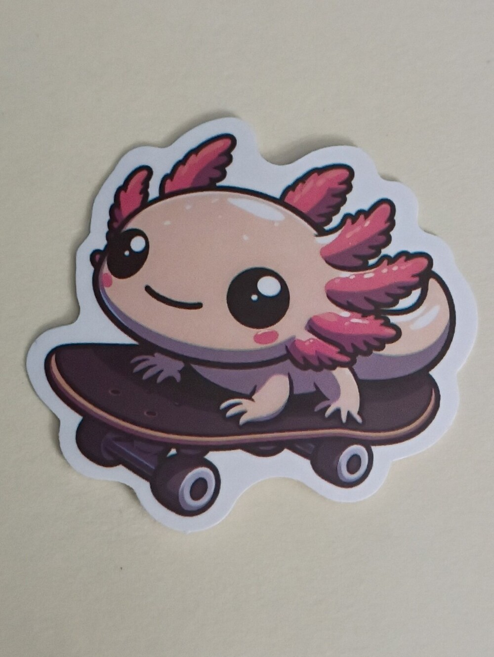10/$10 Sticker - Pink Axolotl Peachy Cream Color Riding A Skateboard